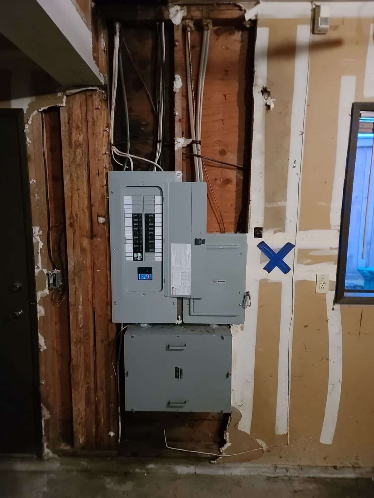 Residential electrical panel mounted between wall studs